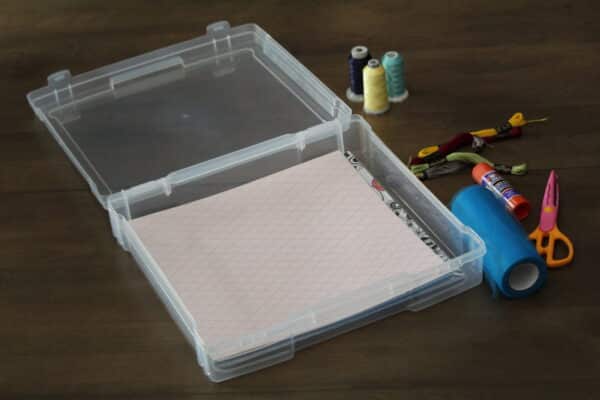 Scrapbook storage case with scrapbooking supplies in it