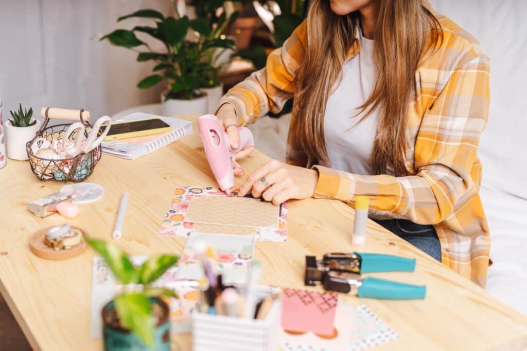 young woman scrapbooking at a table