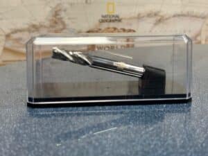 Display case for a metal drill bit, showcasing tools for precision drilling.