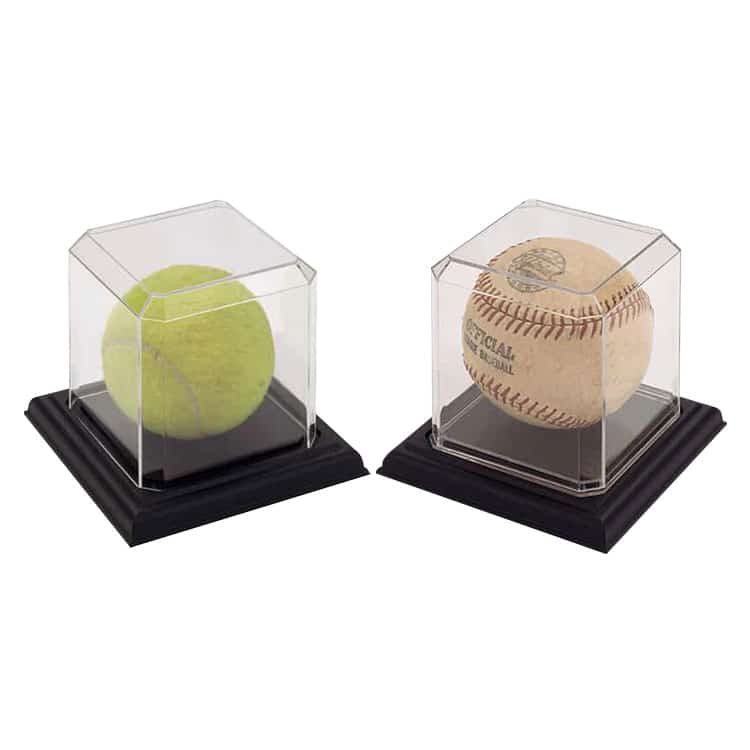 Display cases for collectible sports balls, including a tennis ball and baseball.