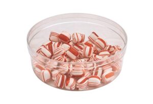 Peppermint candies in a clear container, perfect for festive celebrations and holiday treats.