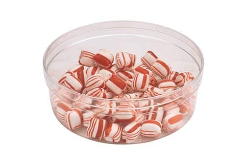 Peppermint candies in a clear container, perfect for festive celebrations and holiday treats.