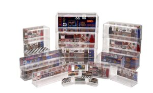 Colorful vintage road signs and memorabilia displayed in clear acrylic boxes.