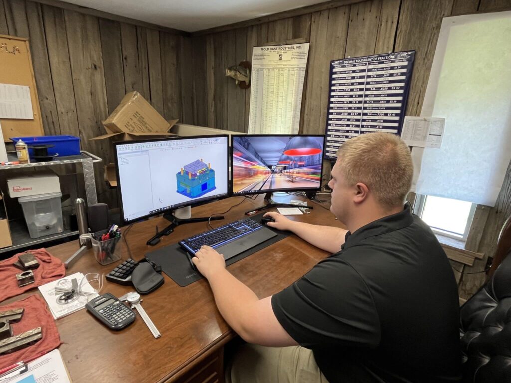 Engineer working on computer in office, designing technical projects and managing workflows.
