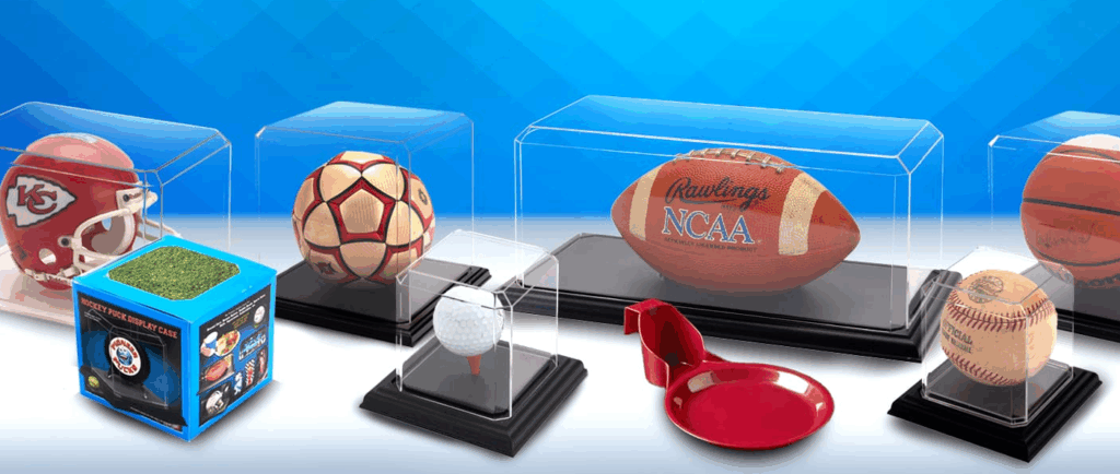 Diverse sports memorabilia displayed in protective cases, featuring balls and collectibles.