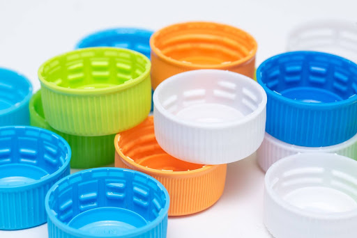Vibrant collection of colorful bottle caps in various shapes and sizes.