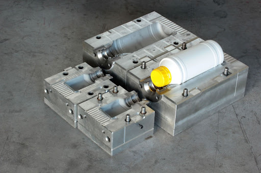 Mold manufacturing process with precision molds and plastic bottle prototype.