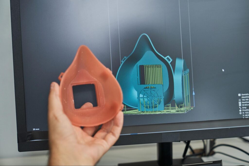 3D printed mask prototype displayed beside computer design visualization conveying Tooling in Manufacturing