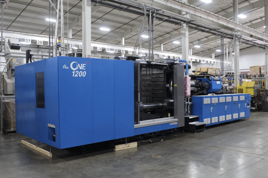 Advanced blue injection molding overmolding machine in a Pioneer Plastics facility.