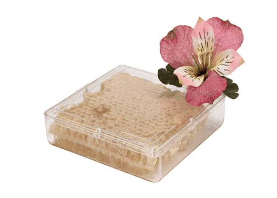 Elegant flower atop a speciality honey container from Pioneer Plastics