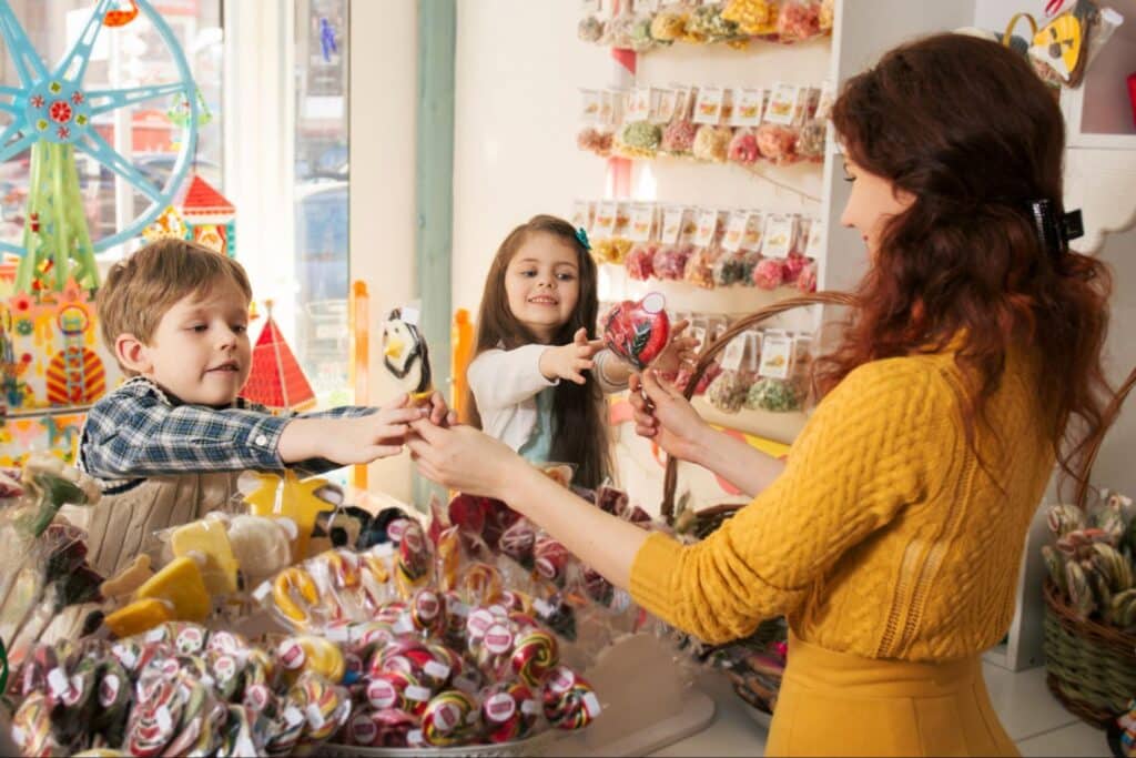Kids happily selecting colorful candies at a vibrant candy store.