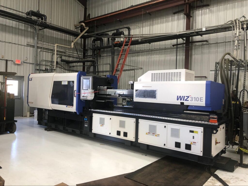 Advanced plastic molding machine in a modern fabrication shop.