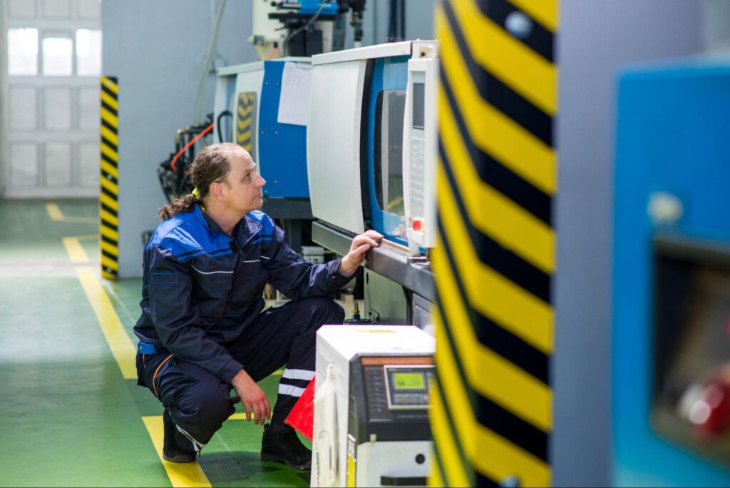Technician inspecting machinery for optimal performance in an industrial facility.