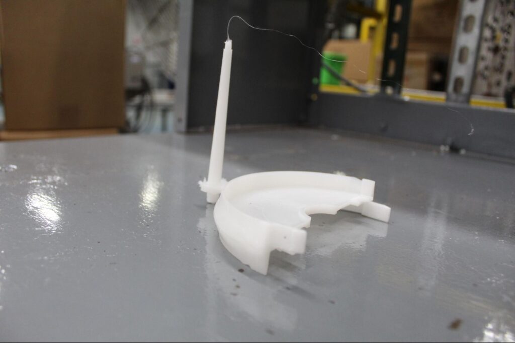 White plastic gate placement part on workbench