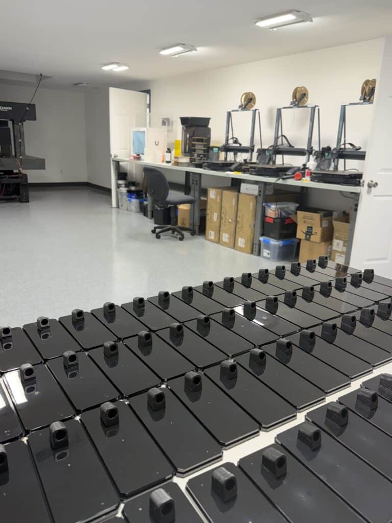 3D printer lab room with resin prints and workstations.