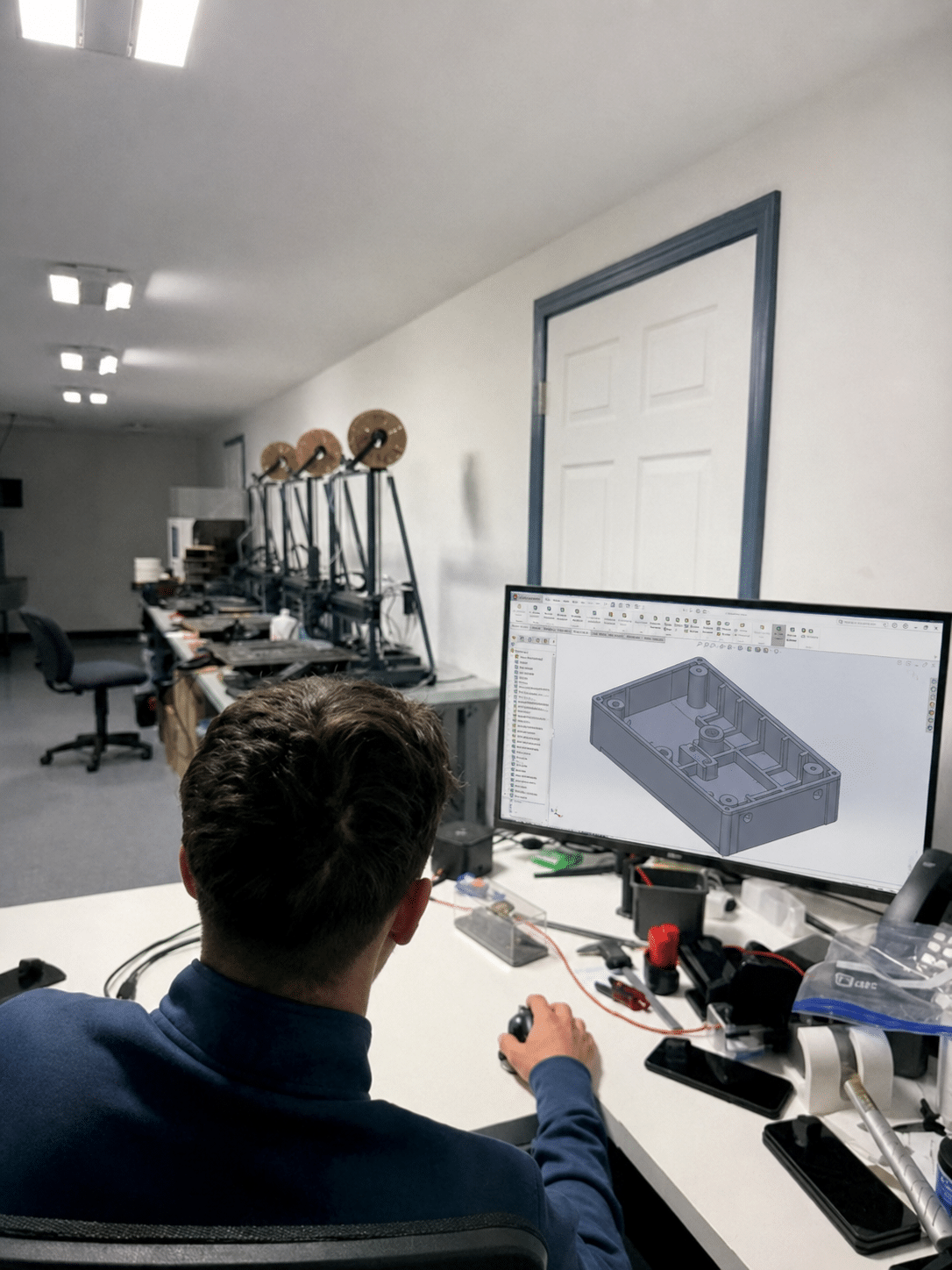 Pioneer Plastics engineer reviewing a 3D CAD part model in the design lab